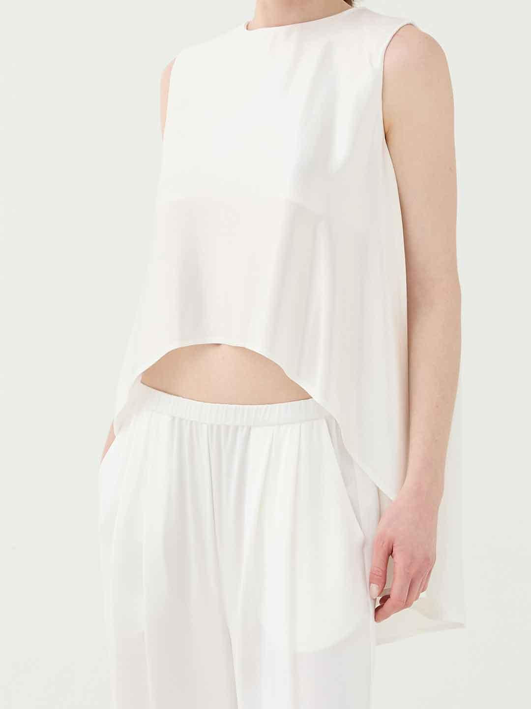 Eleh top bianco con orlo asimmetrico