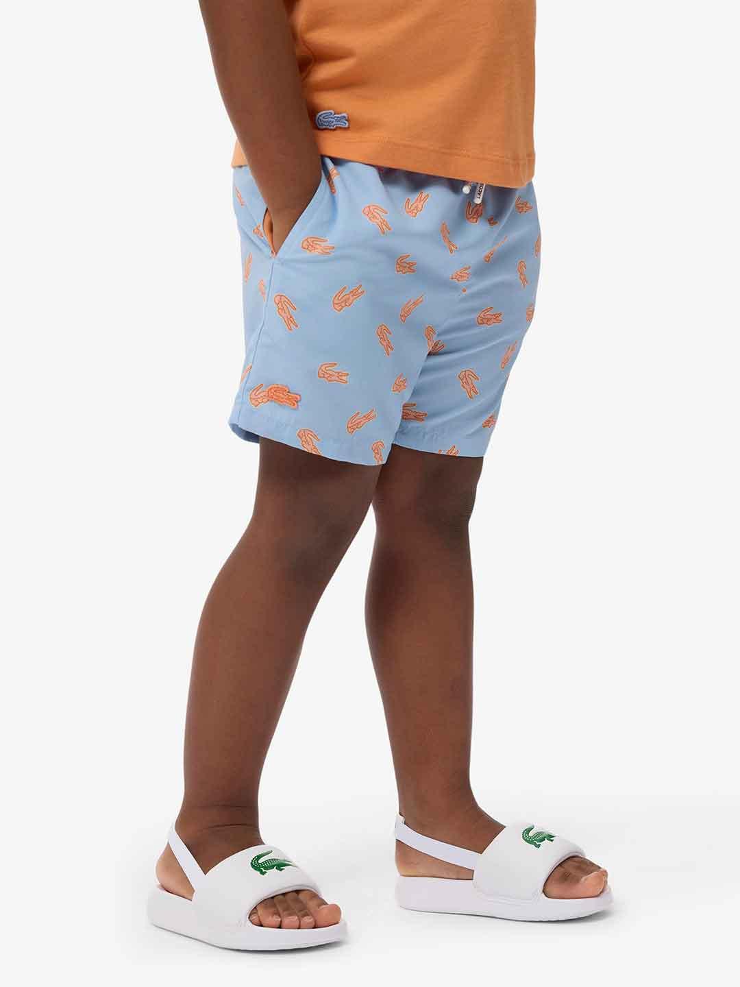 Lacoste costume kids celeste con logo arancio
