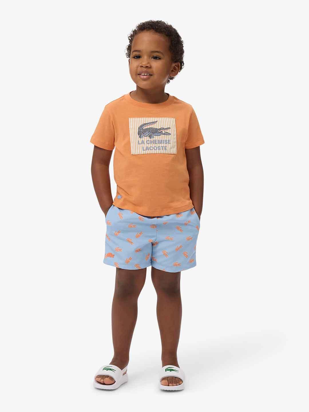 Lacoste costume kids celeste con logo arancio